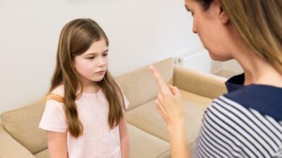mother scolding her daughter living room e1733850365260