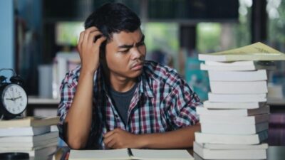 educational conept tired student library e1745997282704